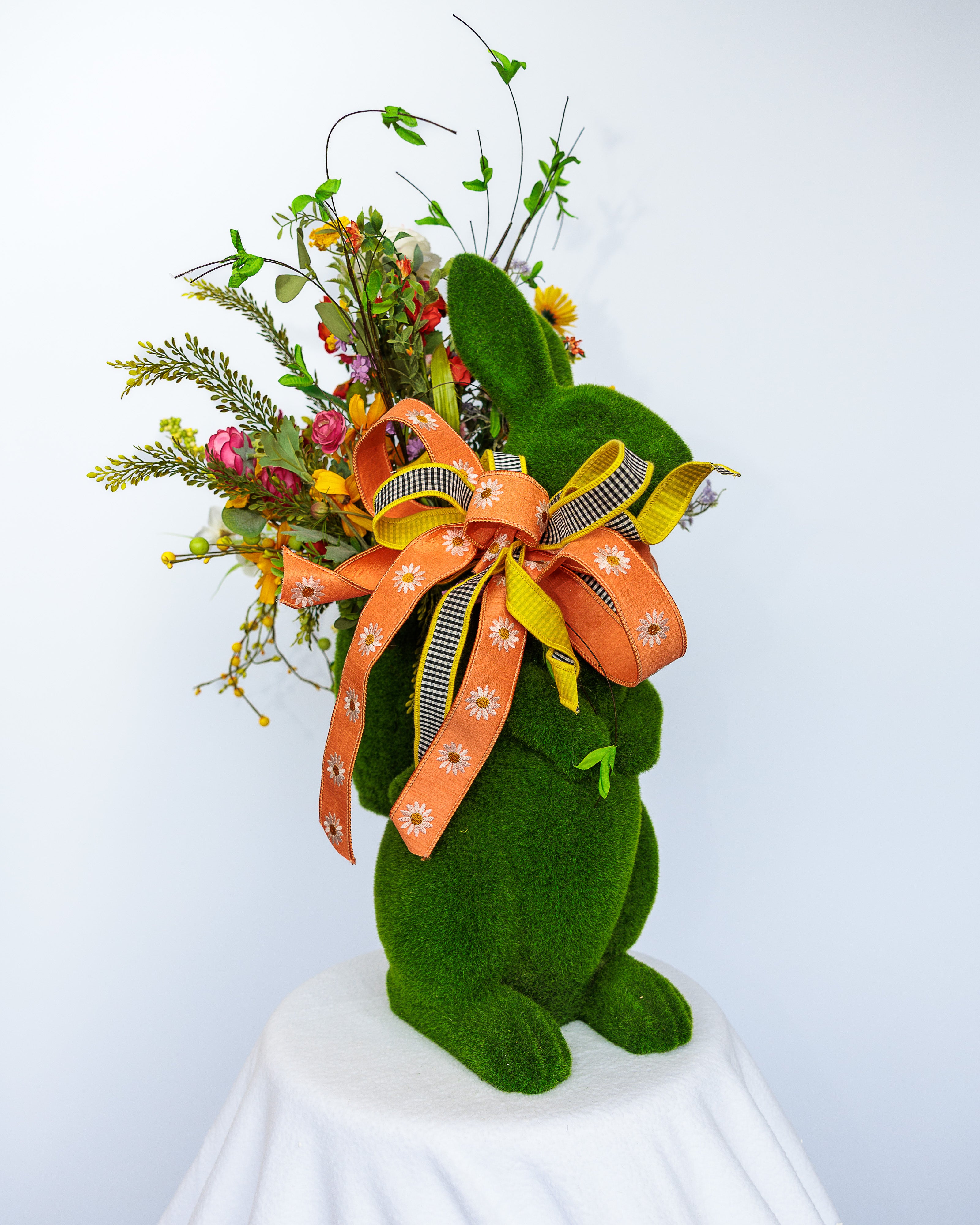 Moss-covered bunny planter with spring florals and bow