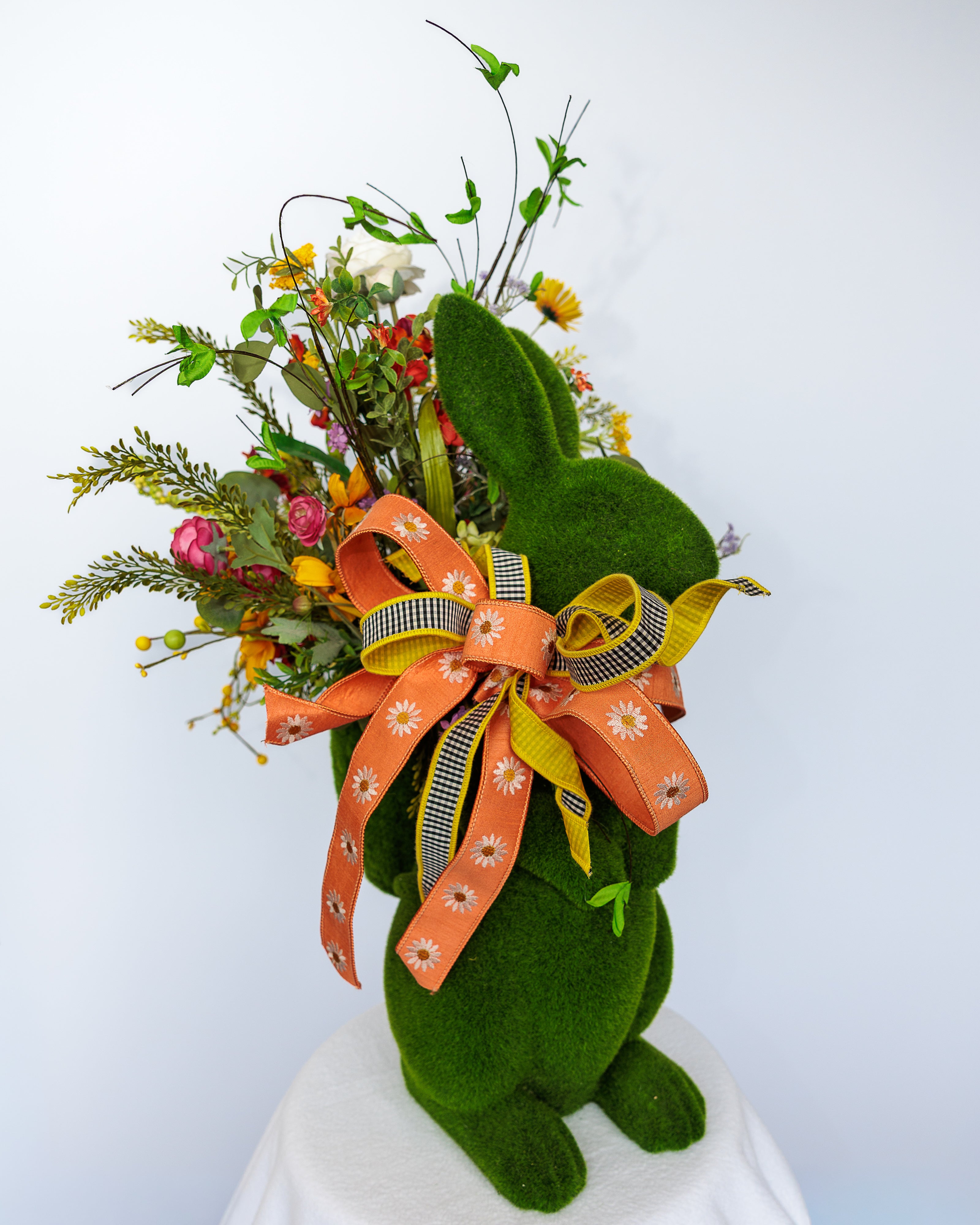 Moss-covered bunny planter with spring florals and bow