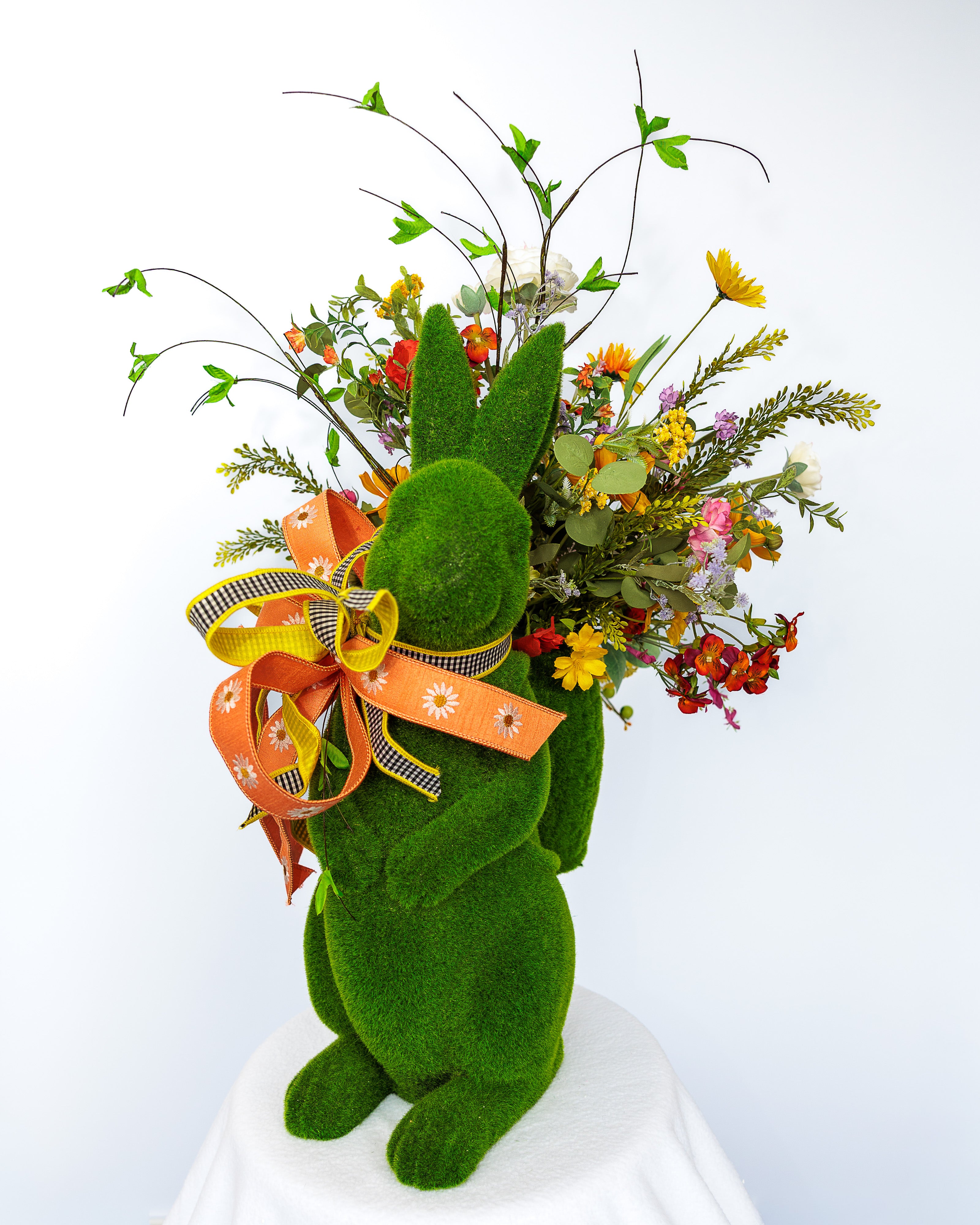 Moss-covered bunny planter with spring florals and bow