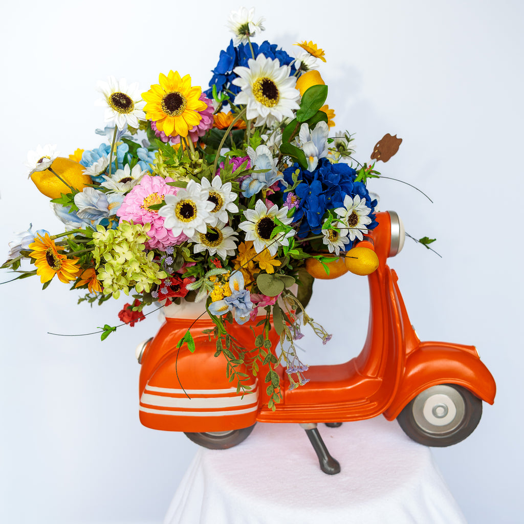 Orange resin scooter planter