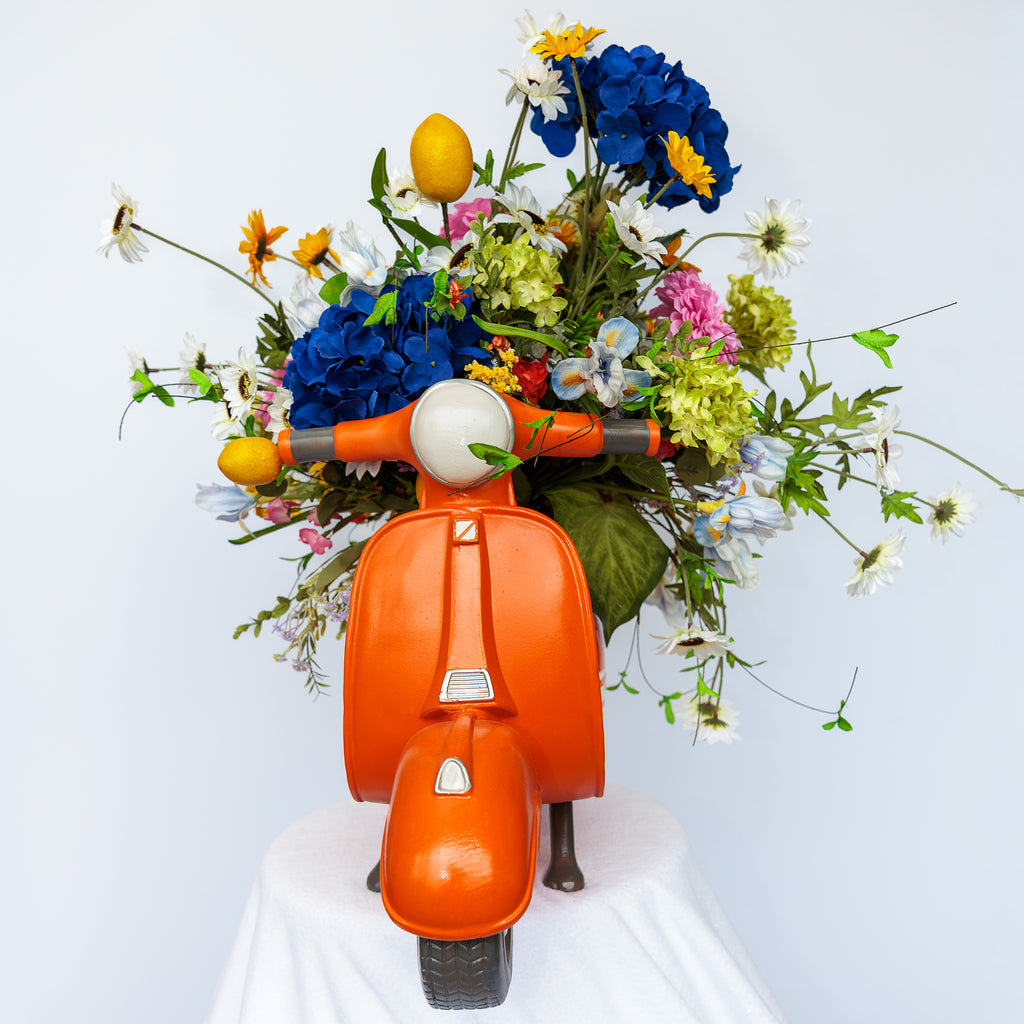 Orange resin scooter planter