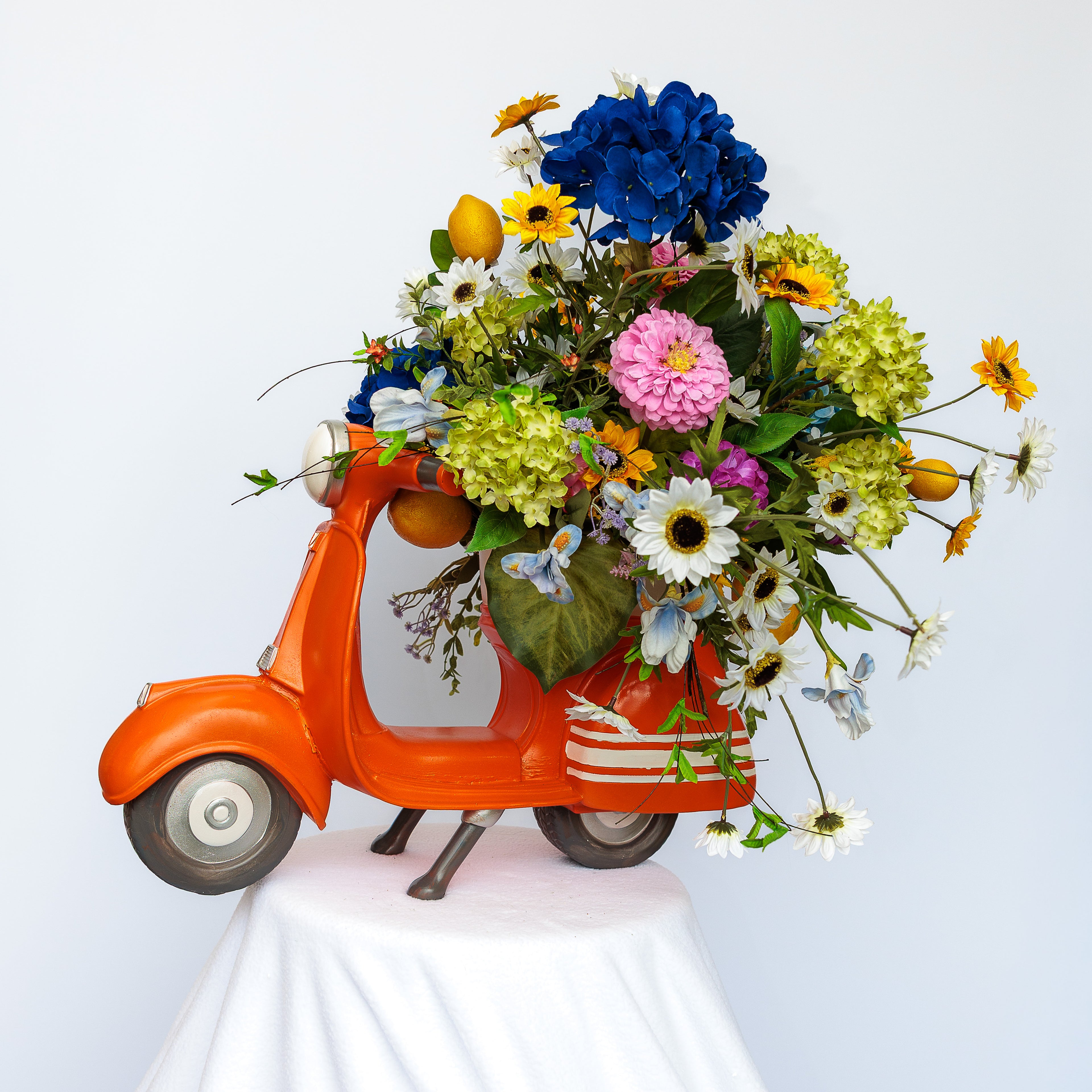 Orange resin scooter planter